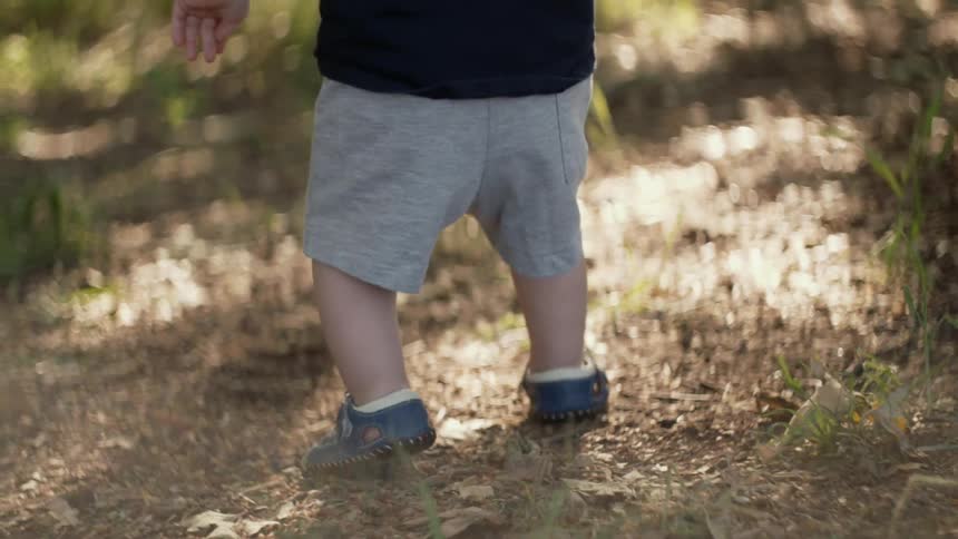 Toddler taking shaky steps outside