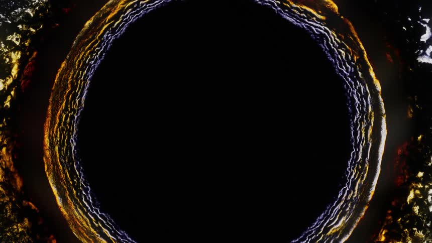 A dark liquid rippling in an expanding circular pattern while reflecting yellow light