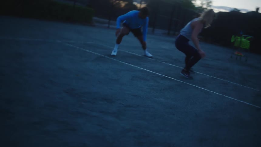 Two tennis players warming up before a match