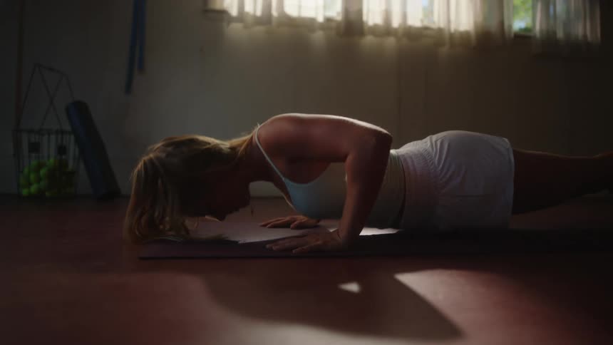 Woman indoor doing pushups