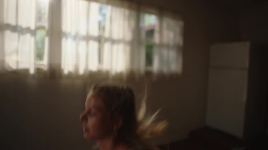 A woman is working out at home