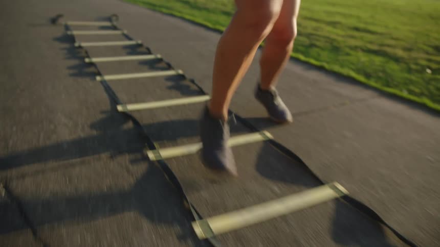 Closeup of the moving legs and feet of a woman running on a ropemarked track