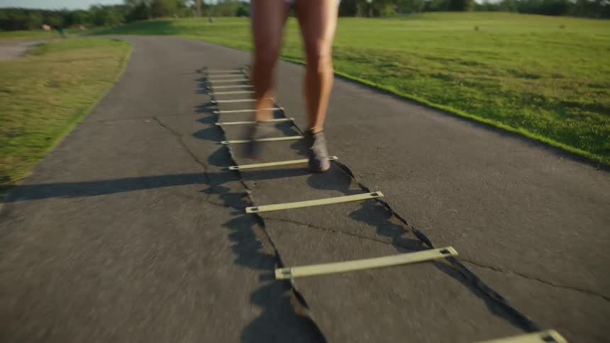 A young female athlete running a footwork challenge