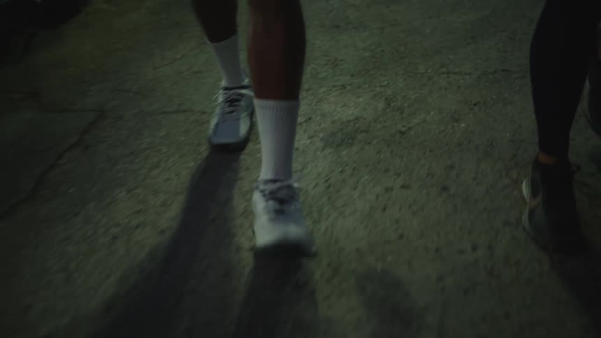Closeup of the legs of two people walking