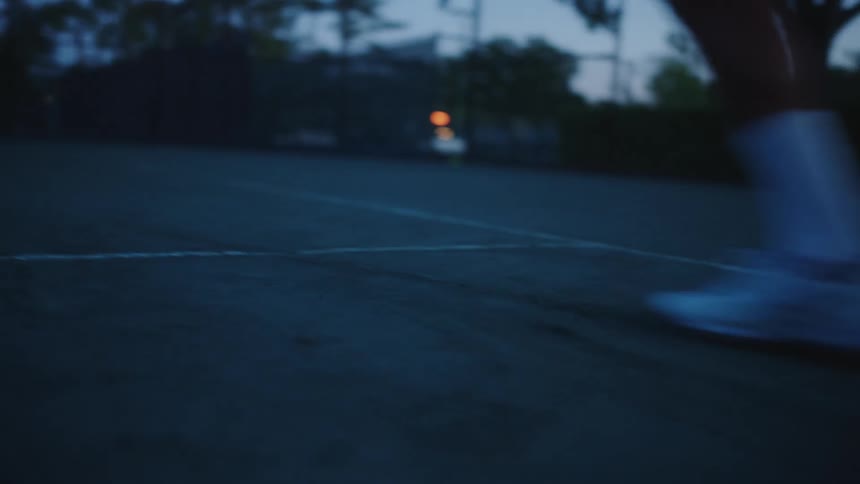 A male tennis player runs sprints on a court