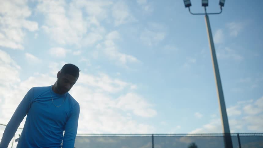 A man practicing his tennis serve