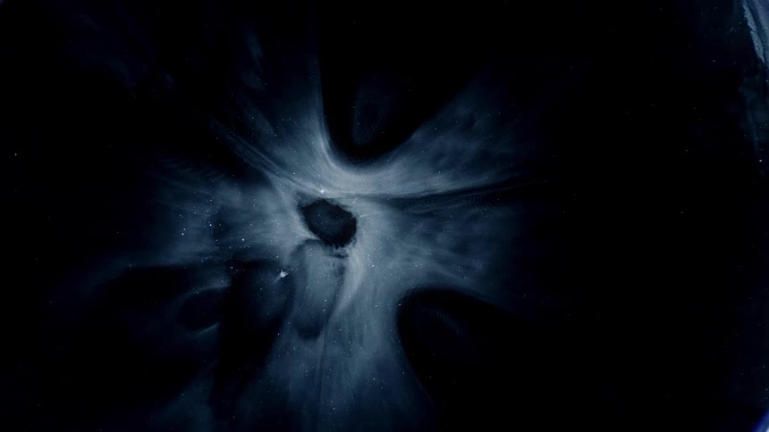 White expands through darkness forming outer rings and an inner bowl