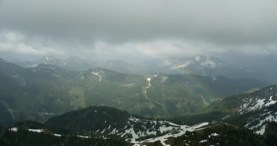 The mountains are covered with fog and trees