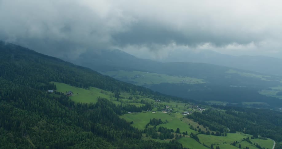 Wooded mountain ranges against a cloudy sky