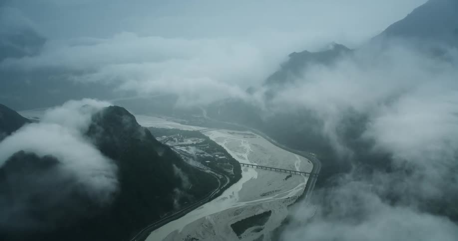 Aerial panorama of a sea canal on the edge of mountains on a foggy day