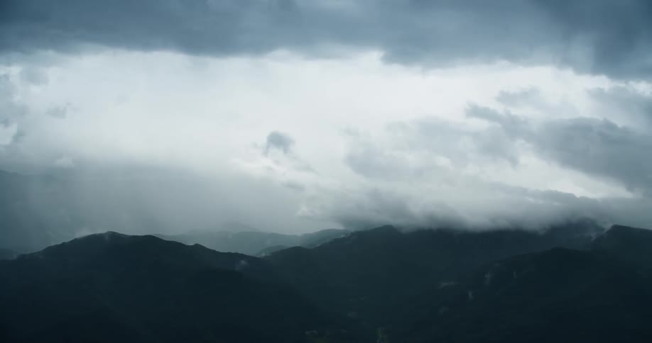 Heavy clouds cast a shade on the mountains