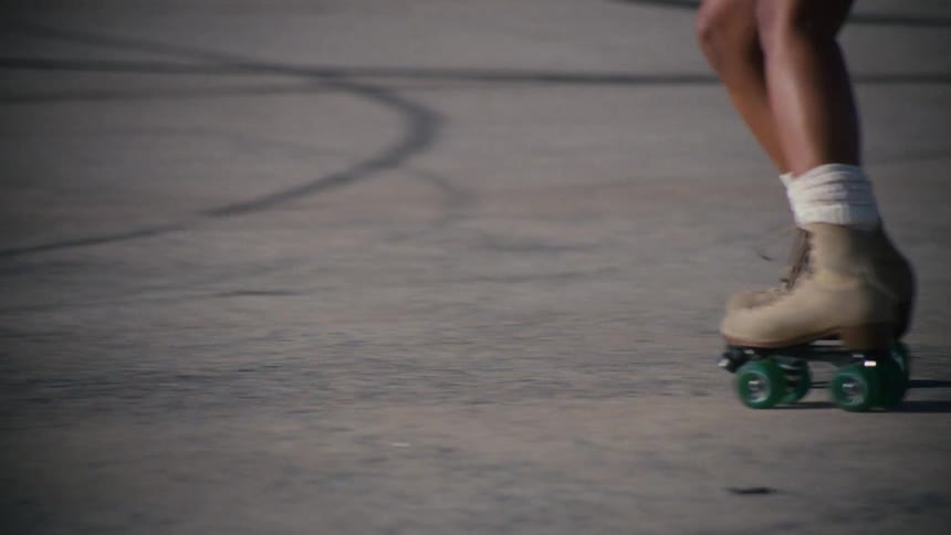 Legs of a woman doing tricks while rollerblading