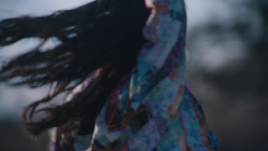 A woman spins around outside