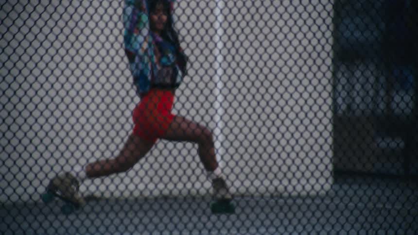 A woman is roller skating in the park