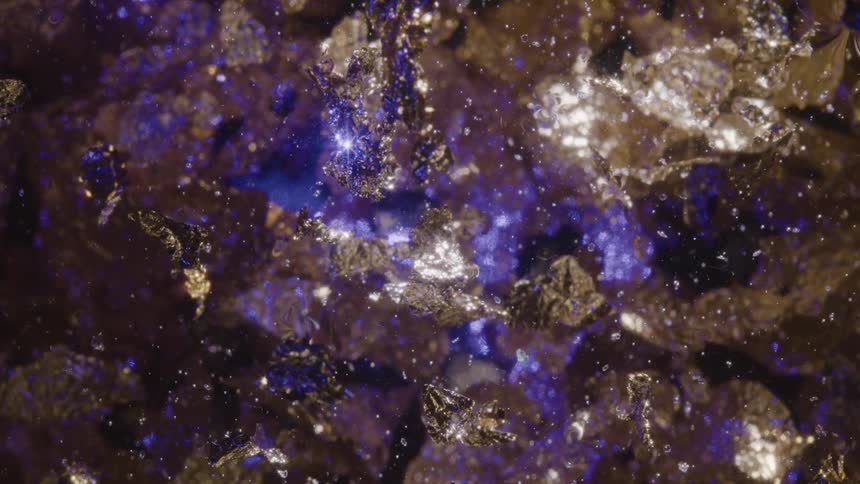 Crystalline stones floating towards each other while reflecting blue and gold light