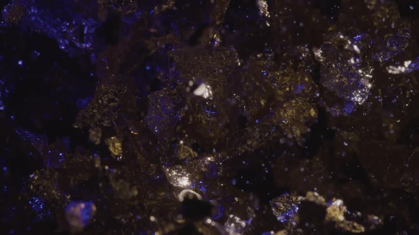 A shiny black surface covered in sparkling glitter
