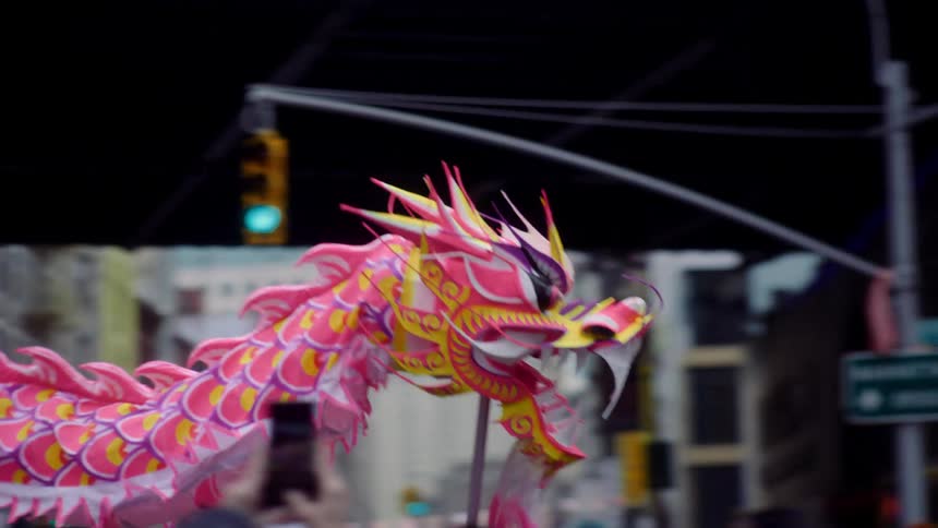 Colorful chinese dragon passing through crowd of people
