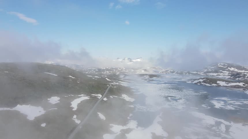 Aerial panorama of snowcovered mountain ranges against a blue sky