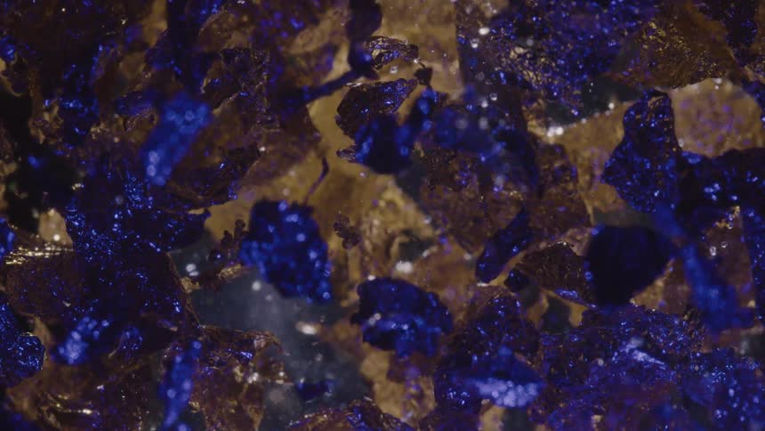 Gray surface of rocks contrast with blue reflecting from gems