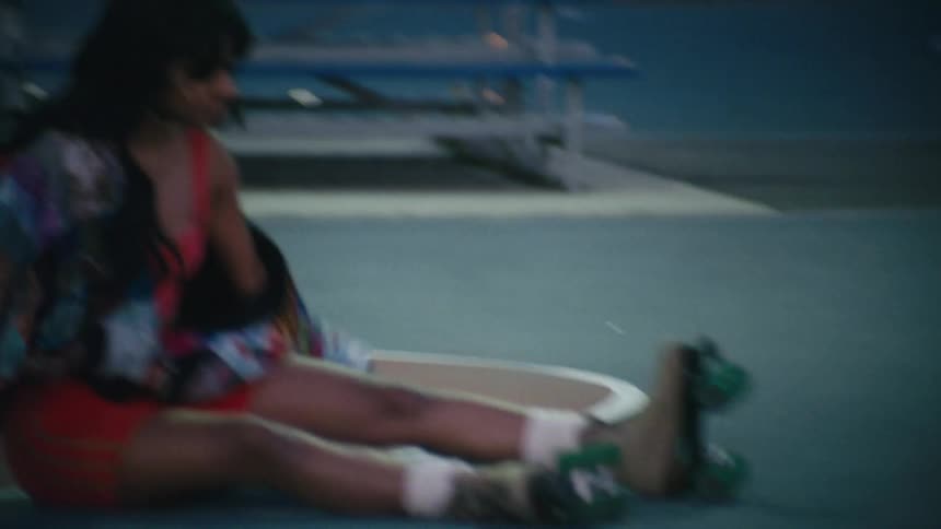 A woman slides on her roller skates on the court