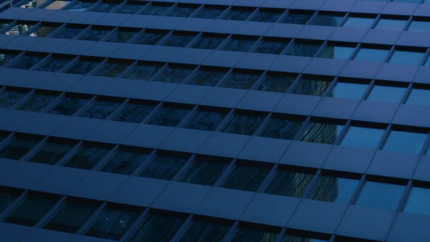 Buildings reflect each other on the windows