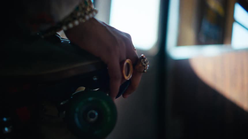 Closeup of a womans hand with rings inside a moving train