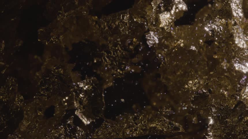 Light is reflecting on the spinning metallic objects