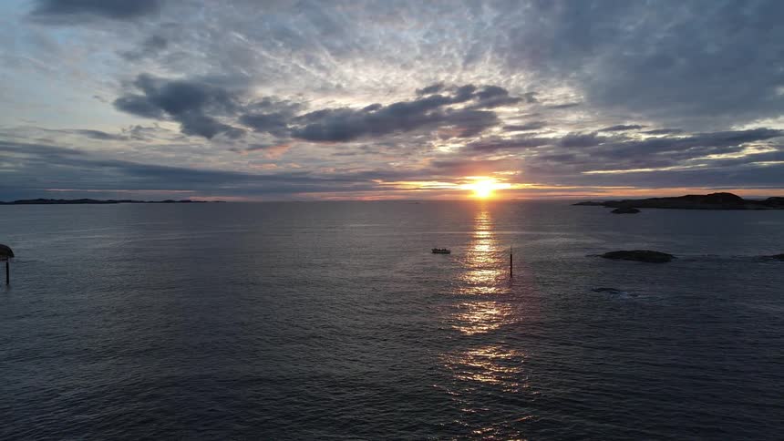 Aerial scenery of a vast ocean with the sunset on the horizon