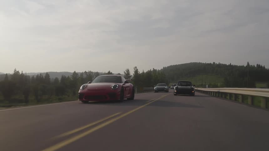 Luxury and sports cars traveling along a highway