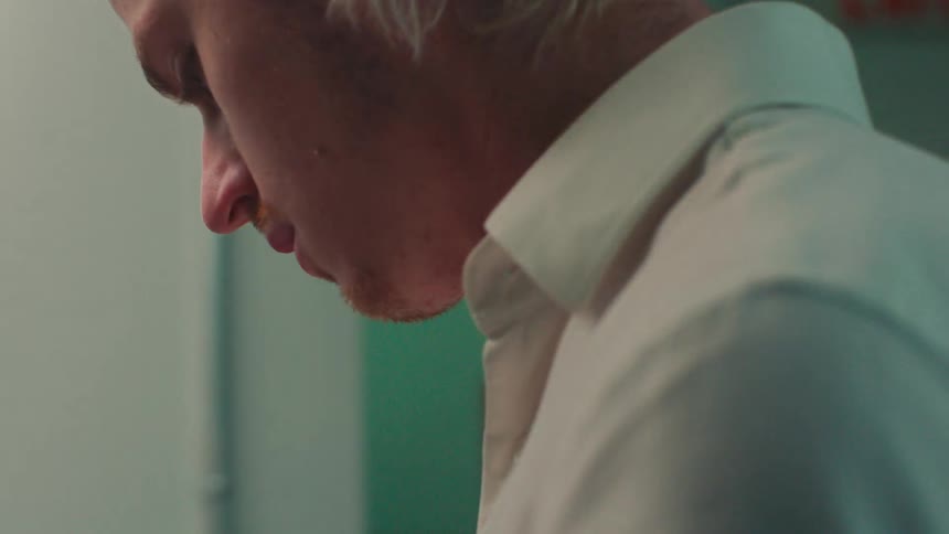 A man pours water into the coffee maker