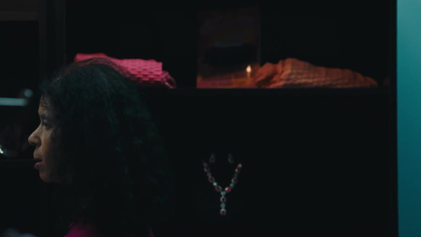 Woman in a bedroom putting away clothes