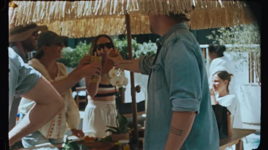 Friends including smiling men and women toasting