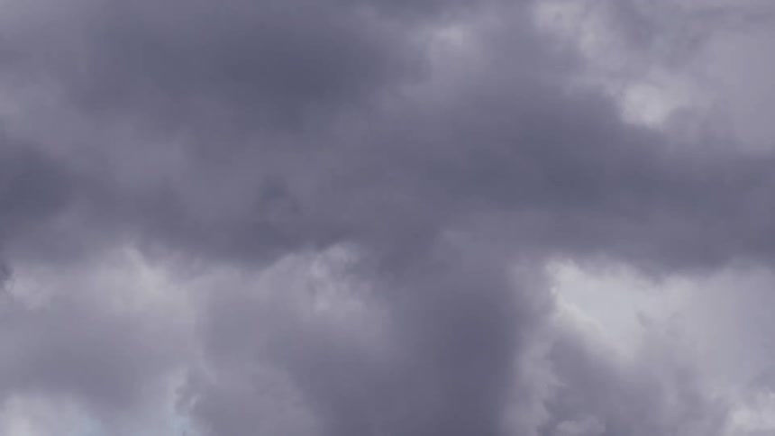 The sky is completely full of fluffy grey clouds which slowly pass overhead