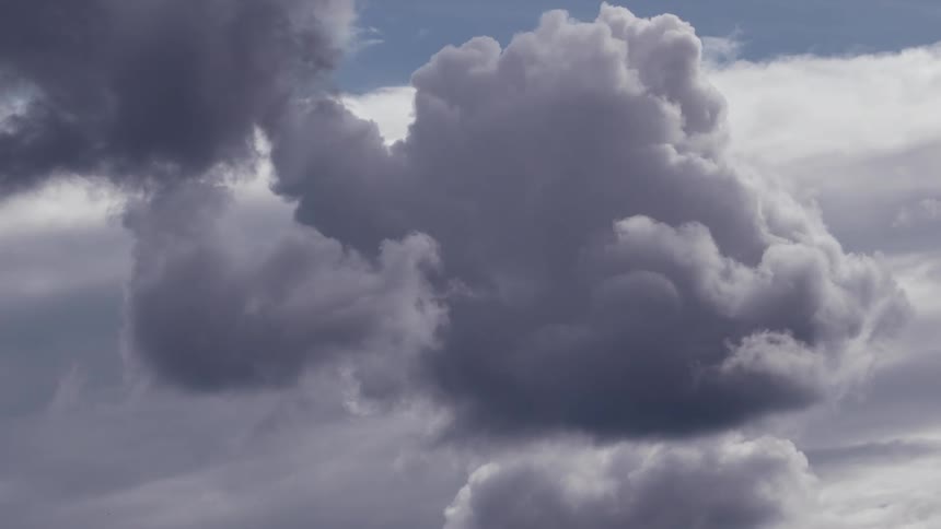 Storm clouds roil in a daytime sky
