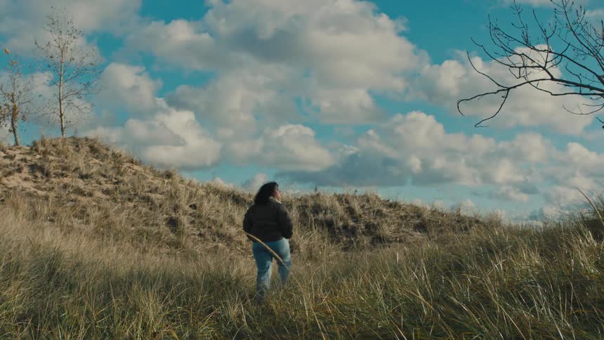 A clip of a lady walking down the bush