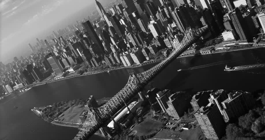 A large bridge connects an island to a major city