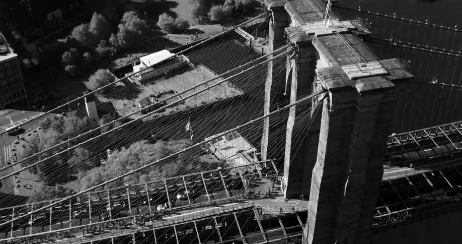 A bridge filled with traffic spans a river