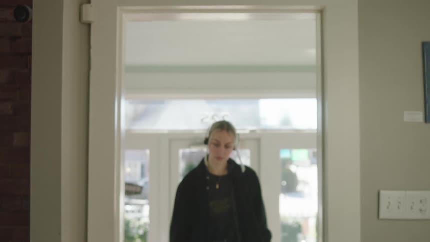Woman enters store pausing to flip the open sign in the front window
