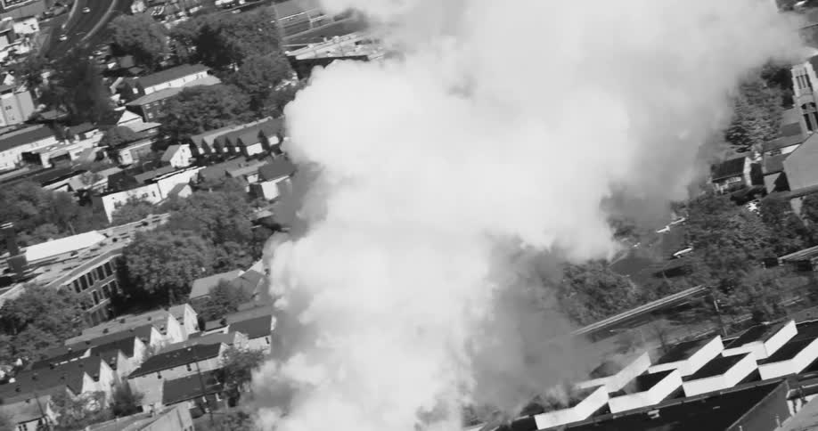 Dense smoke rising in an urban city