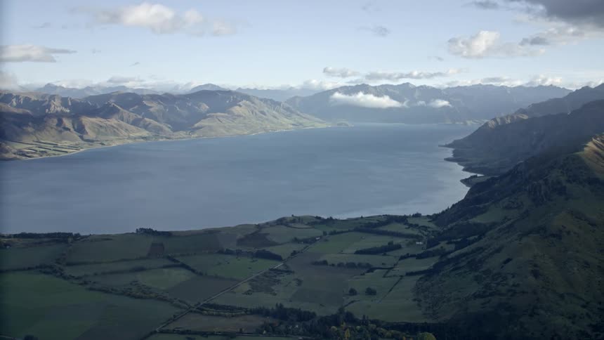 Aerial view of mountains and hills by a lake