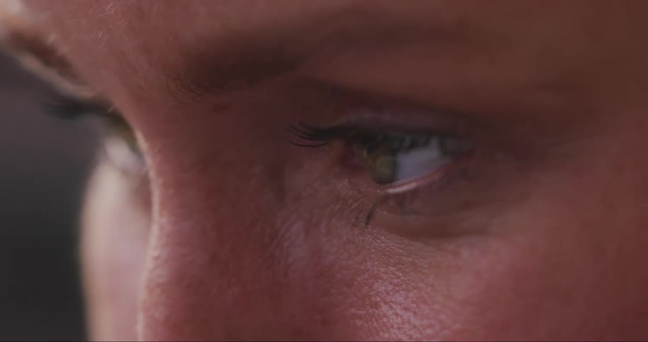 A woman blinks her eyes while looking around