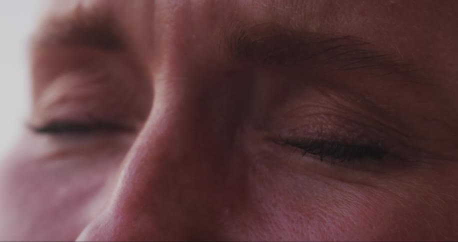 The face of a person with green eyes and they close them for a while and then open them