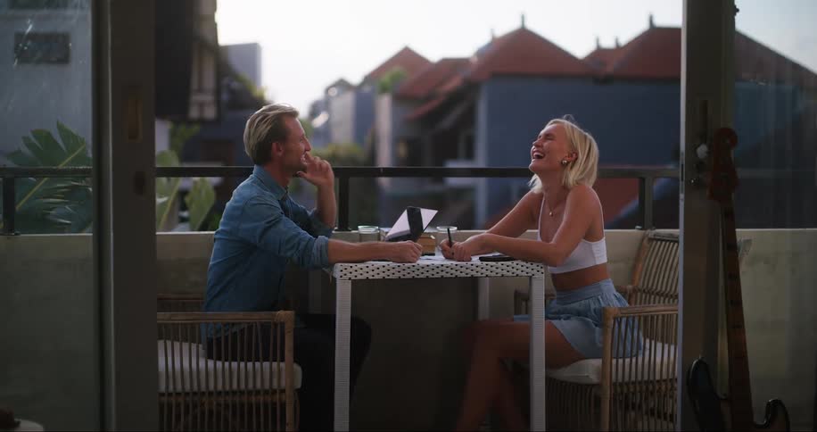 A man and woman laugh and talk