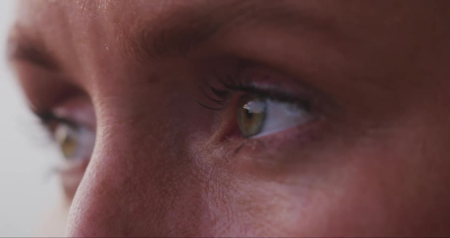 A woman blinks her eyes several times