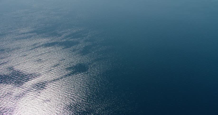 Aerial panorama of the suns reflection over a vast blue ocean