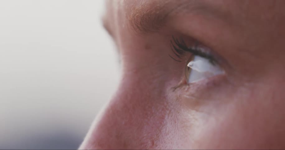 A woman glances around while thinking