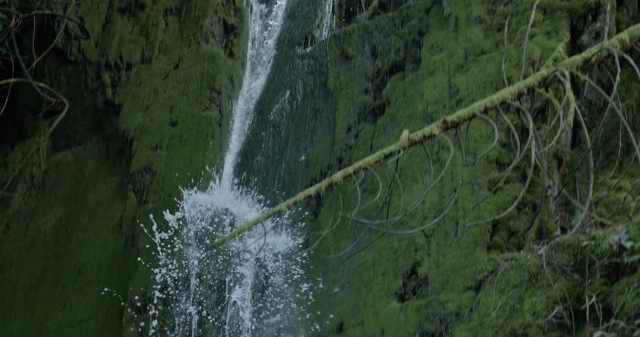 A waterfall is splashing water around as it falls