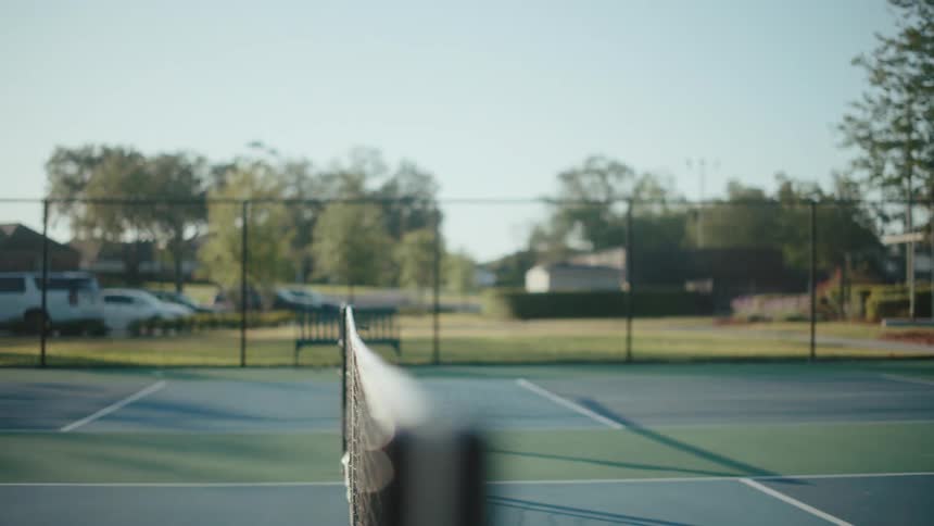 A pickleball being hit back and forth on a pickleball court