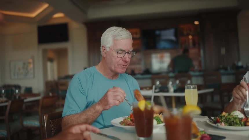 People sitting at a restaurant table having lunch