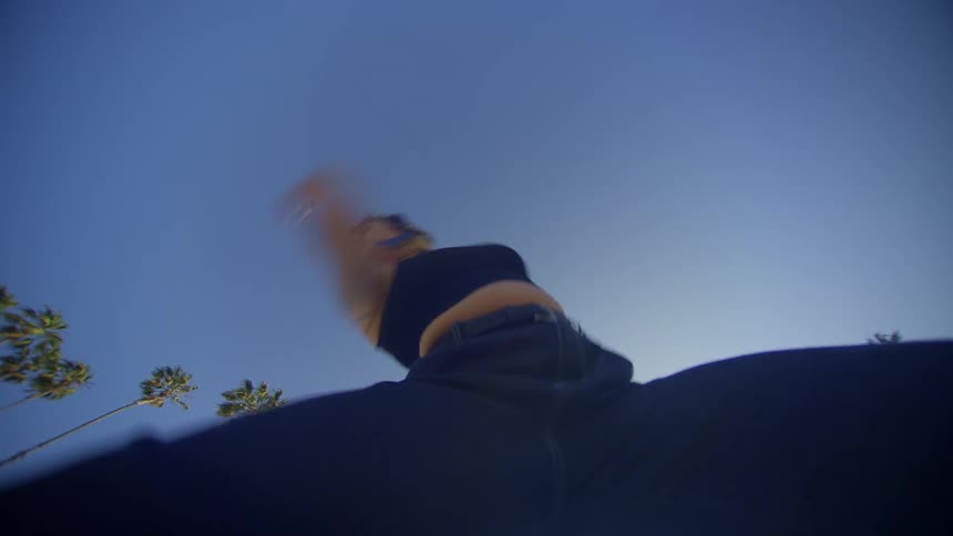 Upward view of a woman dancing in jeans